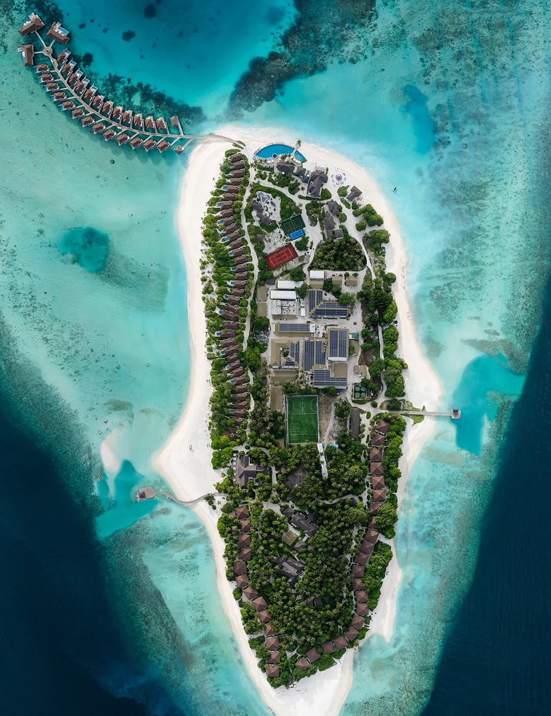 Overhead view of Avani+ Fares Maldives Resort and its surrounding reef